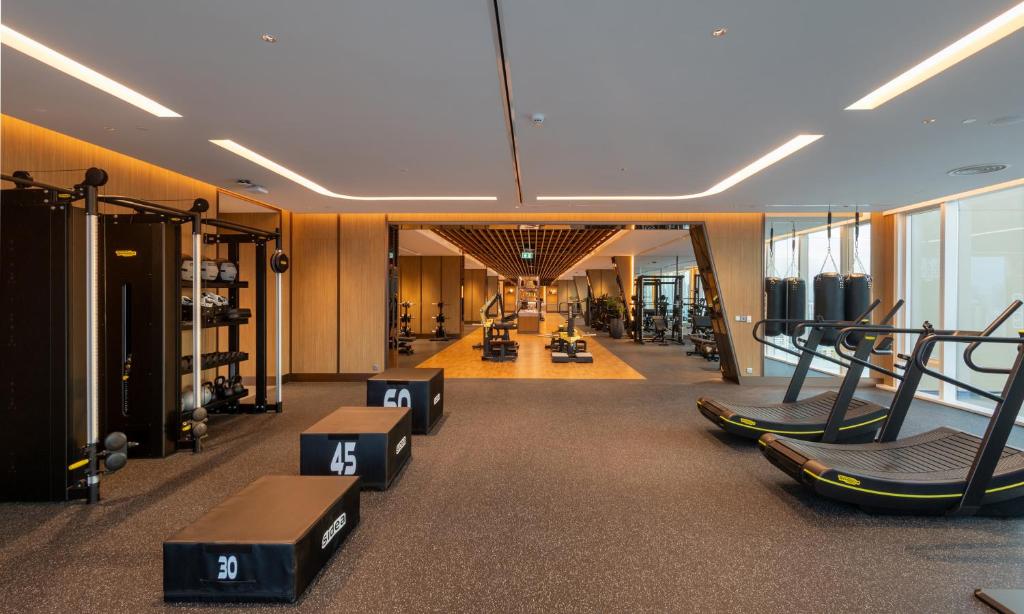 A spacious fitness room combining cardio, weights, and functional training equipment.