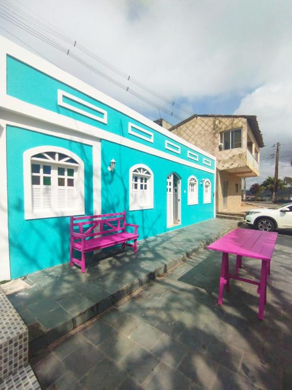 a blue building with a pink table in front of it at Solar dos Ventos BANANEIRAS in Bananeiras