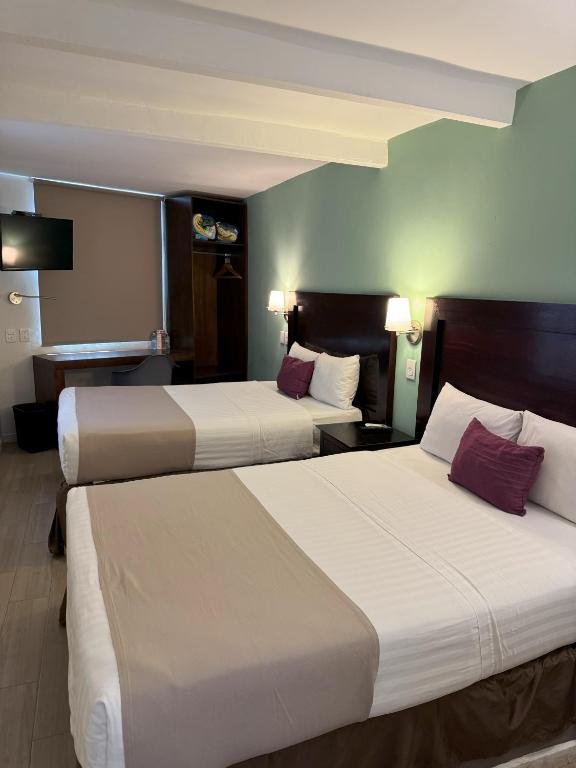 Postel nebo postele na pokoji v ubytování Hotel Arribo