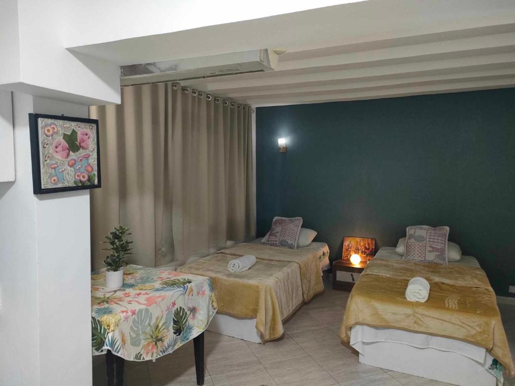 a room with two beds and a table with a lamp at comfort marine 2 in Hurghada
