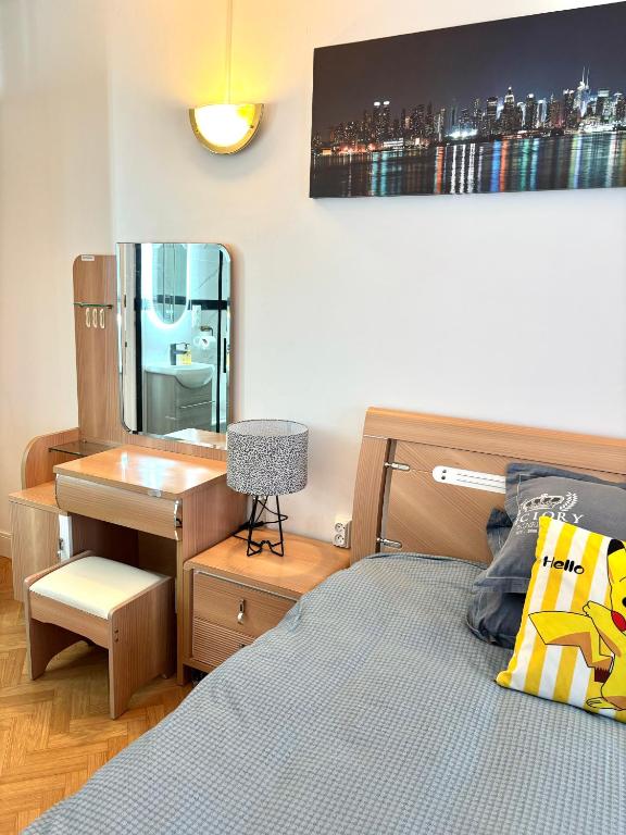 a bedroom with a bed with a desk and a desk at Chambre Lucas Salle de bain Privative in Paris
