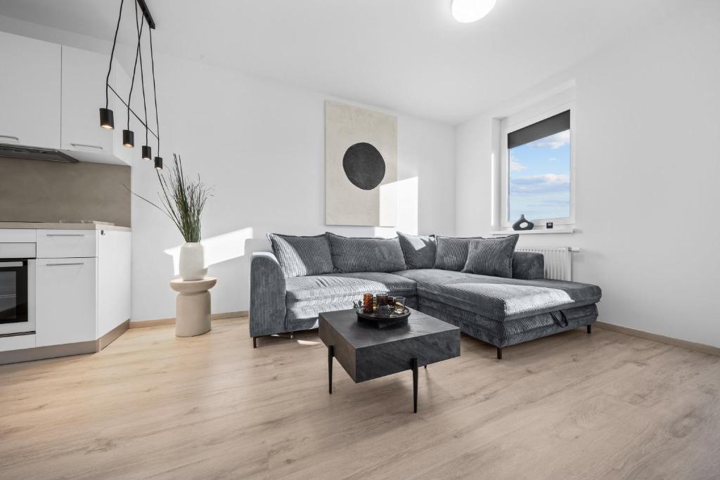 a living room with a couch and a table at Modern 2-Bedroom Apartment in the Heart of Bratislava in Bratislava