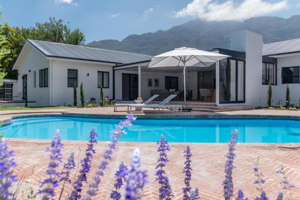 a villa with a swimming pool and a house at Maison la Bruyere, 8p villa - heated pool, airco & hottub in Franschhoek