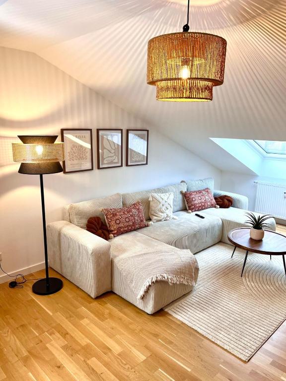 a living room with a couch and a table at 2-Zimmer Apartment - Zentral über den Dächern von Aschaffenburg - 5 min vom HBF - Gegenüber City Galerie in Aschaffenburg