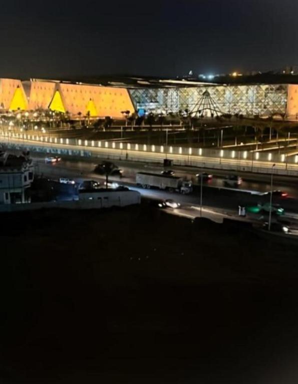 a night view of a highway with cars and lights at Pyramids Heritage suites in Ghaţāţī