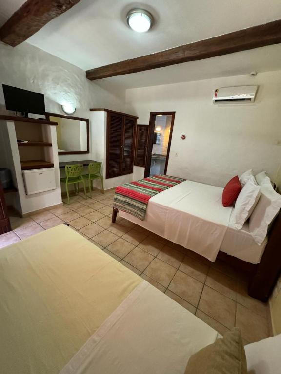 Cama ou camas em um quarto em Pousada Tambayba