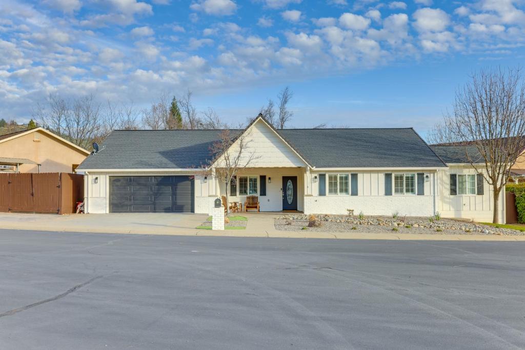 a white house with a driveway in front of it at Walk Downtown Remodeled Home in Murphys with Yard! in Murphys