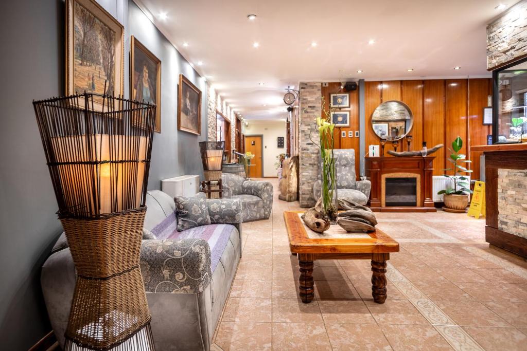 a living room with a couch and a table at Hotel Royal Victoria in Victoria