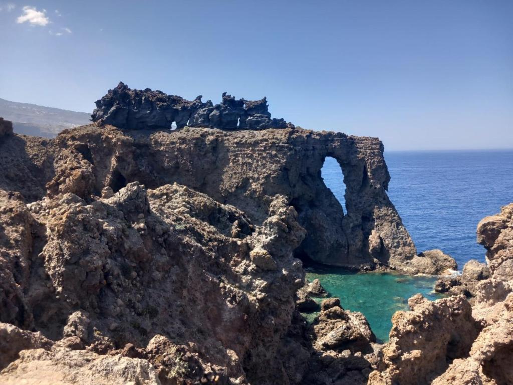 an arch in the rocks near the ocean at La cuadra de Juan in Icod de los Vinos