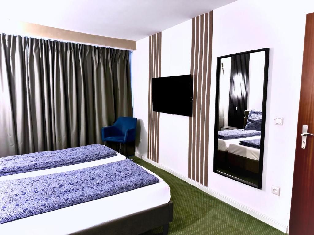 Postel nebo postele na pokoji v ubytování Hotel Hamburg Inn