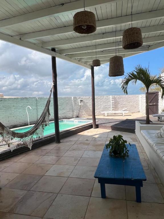a patio with a hammock and a swimming pool at Casa Free Wind Jeri in Jericoacoara