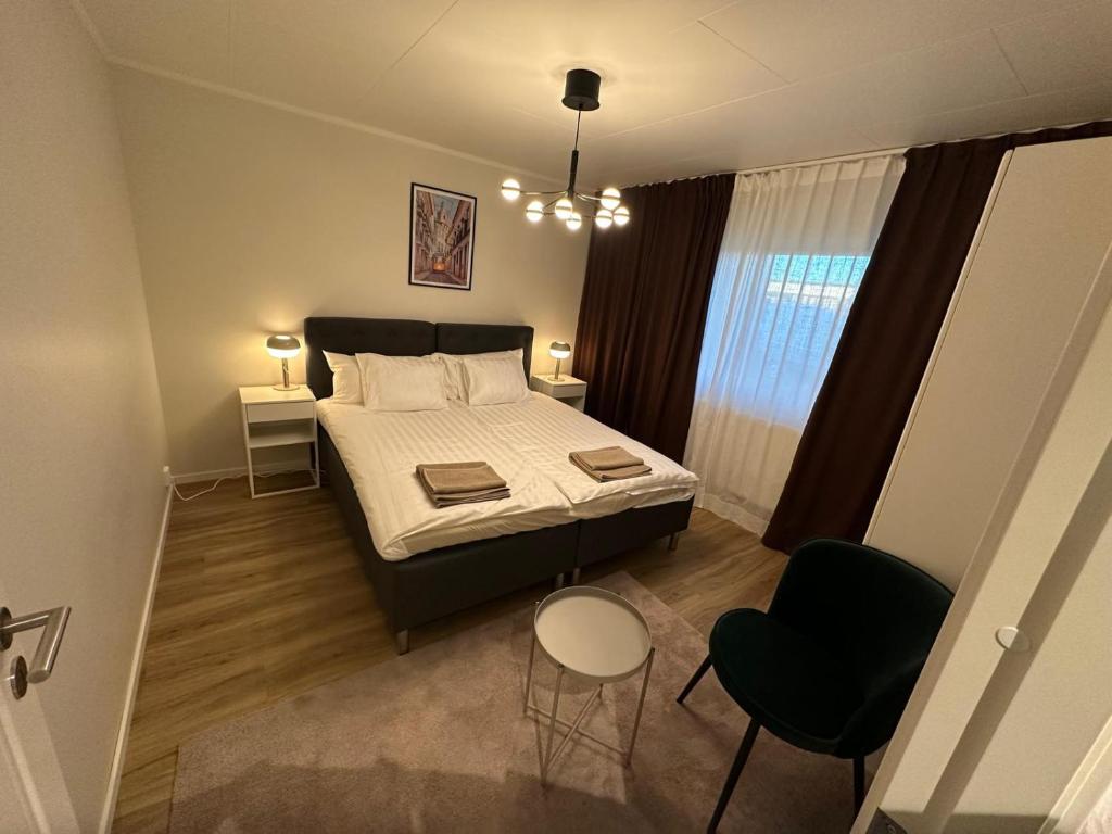 una pequeña habitación con una cama y dos sillas en Noah Longstay Stålverksgatan 25, en Västerås