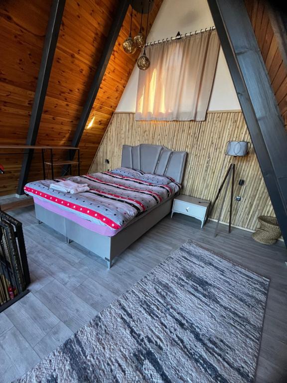 una cama en una habitación con techo de madera en DREAM DELUXE SAPANCa, en Sapanca