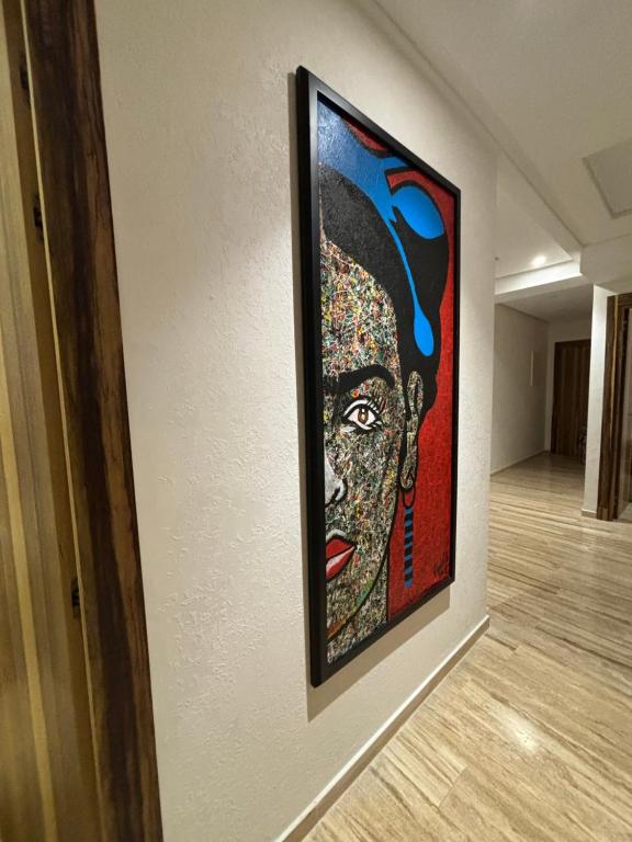 a painting of a woman on a wall at Appartement de Luxe Tanger Centre & Nouveau Stade in Tangier