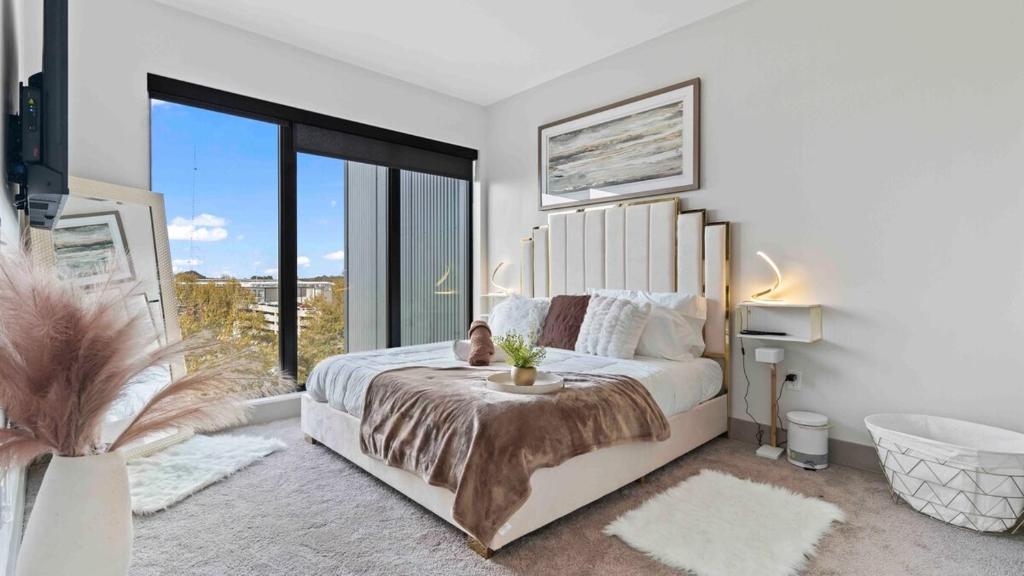 a bedroom with a large bed and a large window at NEW! ChateauOasis PenthouseViews KingBed FreePark in Atlanta