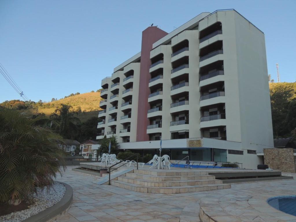 a large white building with a fountain in front of it at San Marino in Águas de Lindóia