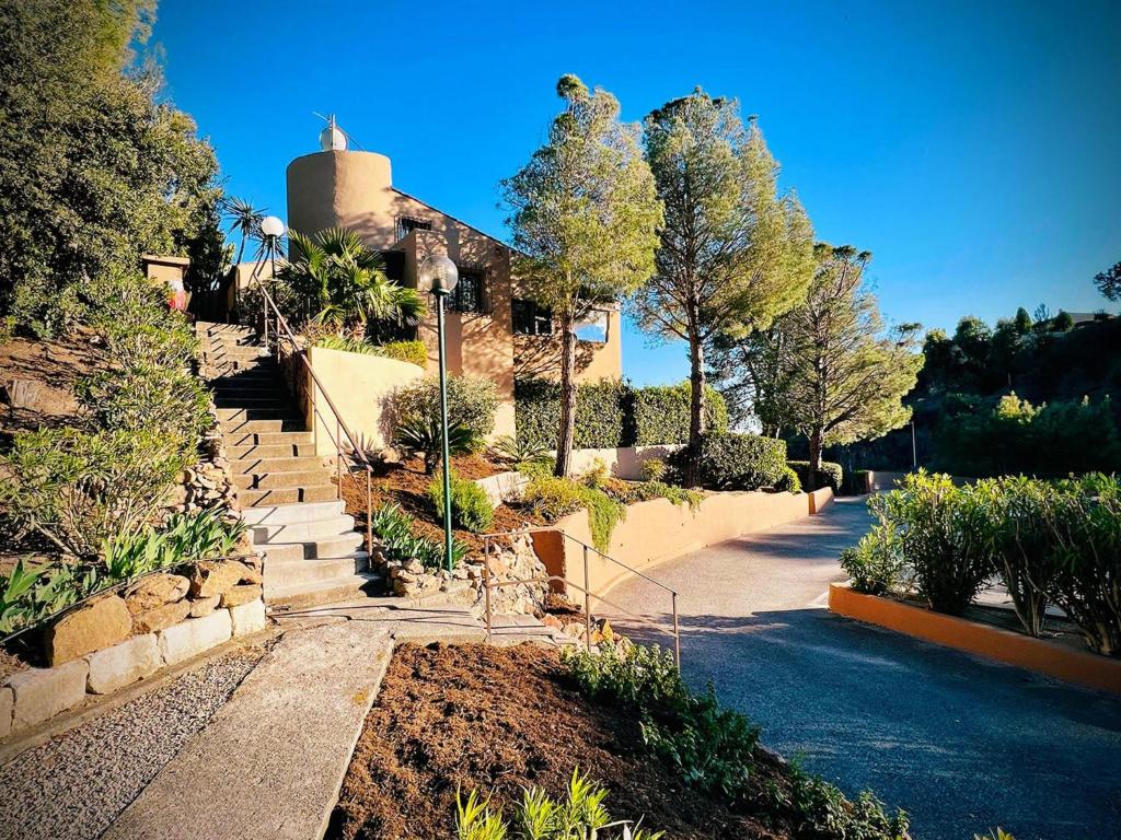 une maison avec un escalier en face d'une cour dans l'établissement La Bussola, à Théoule-sur-Mer