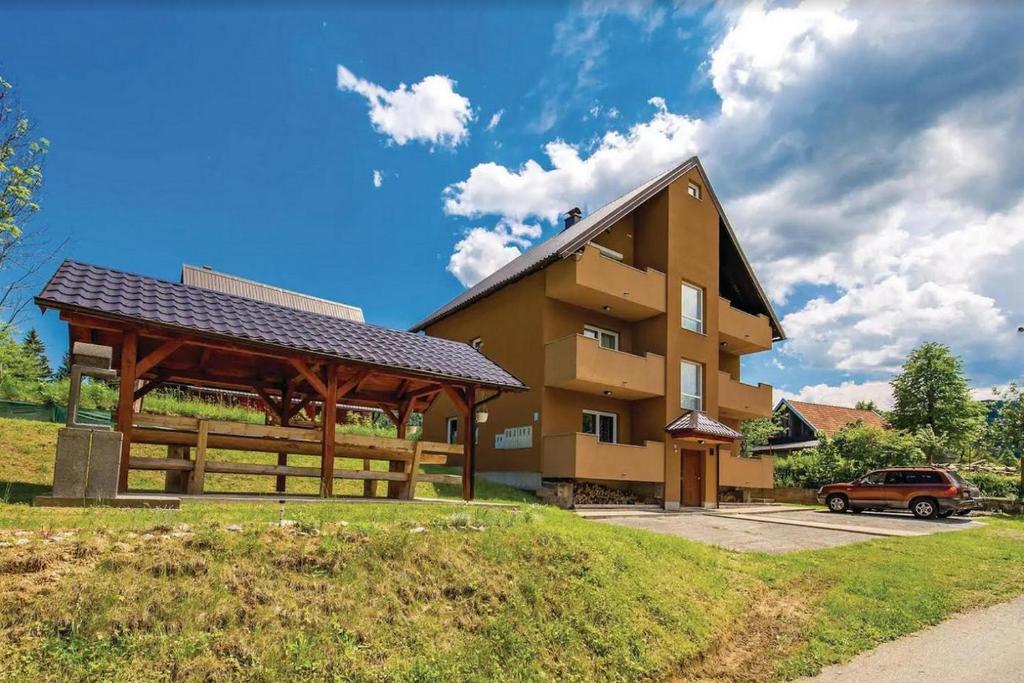 a building with a gazebo in front of it at Apartments for families with children Jasenak, Karlovac - 17501 in Jasenak