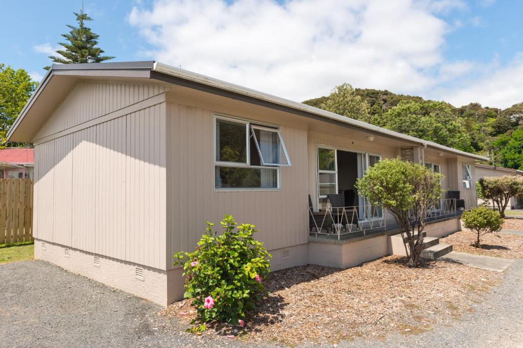 
a house with a porch and a window at Te Tiriti Units in Paihia
