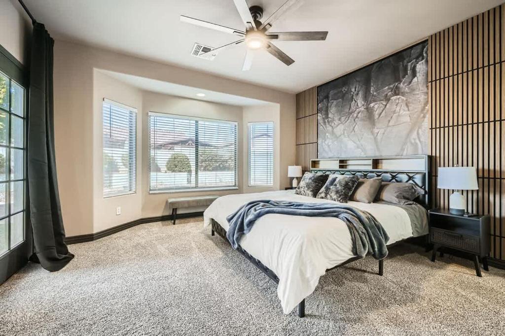 a bedroom with a bed and a ceiling fan at Whitton House - Hot Tub - Fire Pit - Pets OK in Avondale