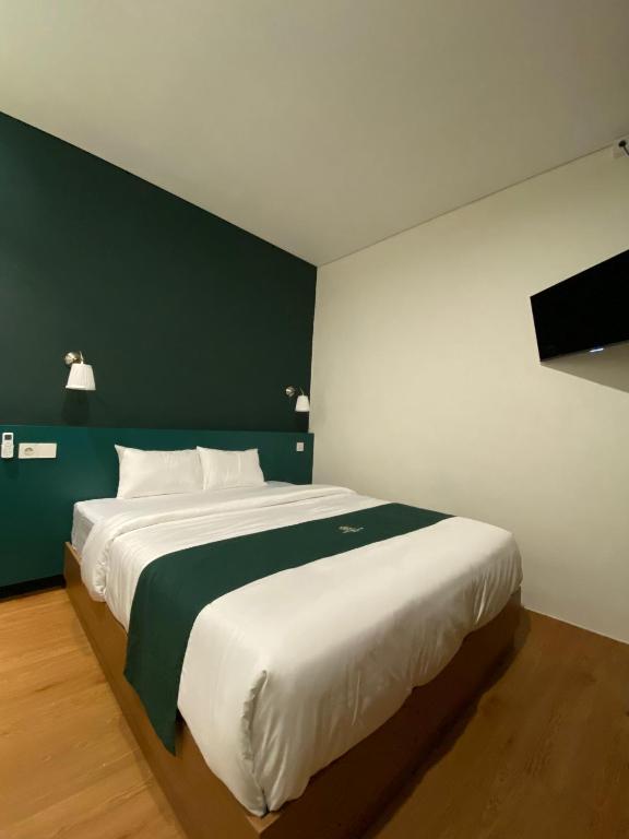Postel nebo postele na pokoji v ubytování Agung Guest House by RF