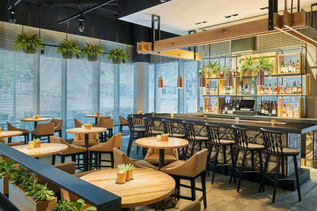 a restaurant with tables and chairs and a bar at Aloft Austin Downtown in Austin