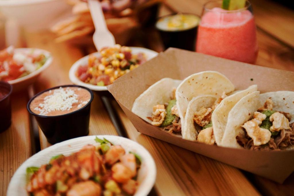 a table topped with tacos and other dishes of food at Aloft Austin Downtown in Austin