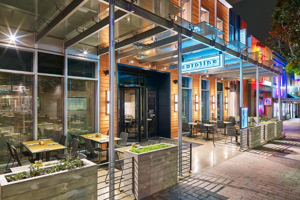 a restaurant with tables and chairs outside of a building at Aloft Austin Downtown in Austin