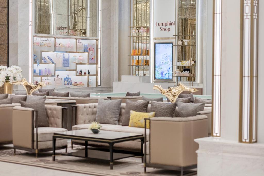 A plush lounge seating area is arranged around the hotel shop.