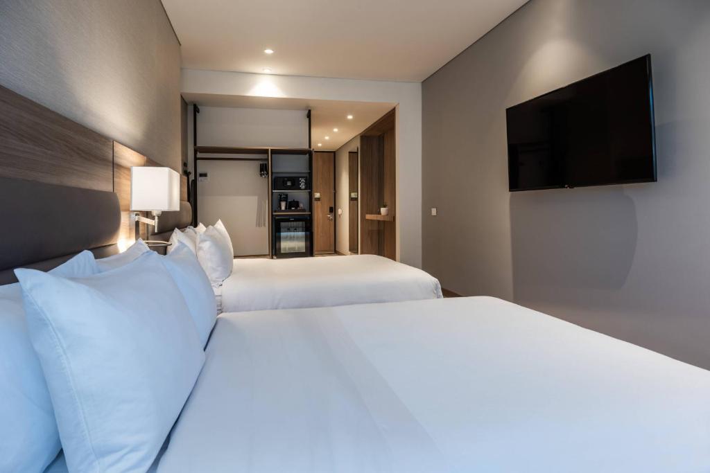 Postel nebo postele na pokoji v ubytování AC Hotel by Marriott Bogota Zona T