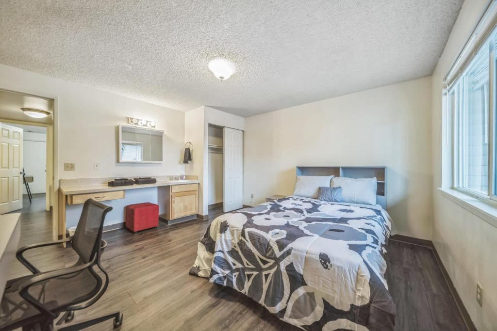 a bedroom with a bed and a desk and a chair at WSU HomeBase - Where Comfort Meets Convenience in Pullman