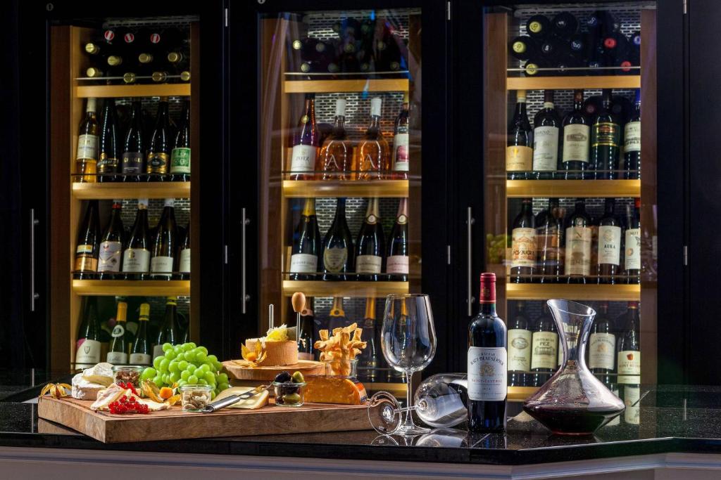 a bar with a bunch of bottles of wine at Courtyard by Marriott Hamburg Airport in Hamburg