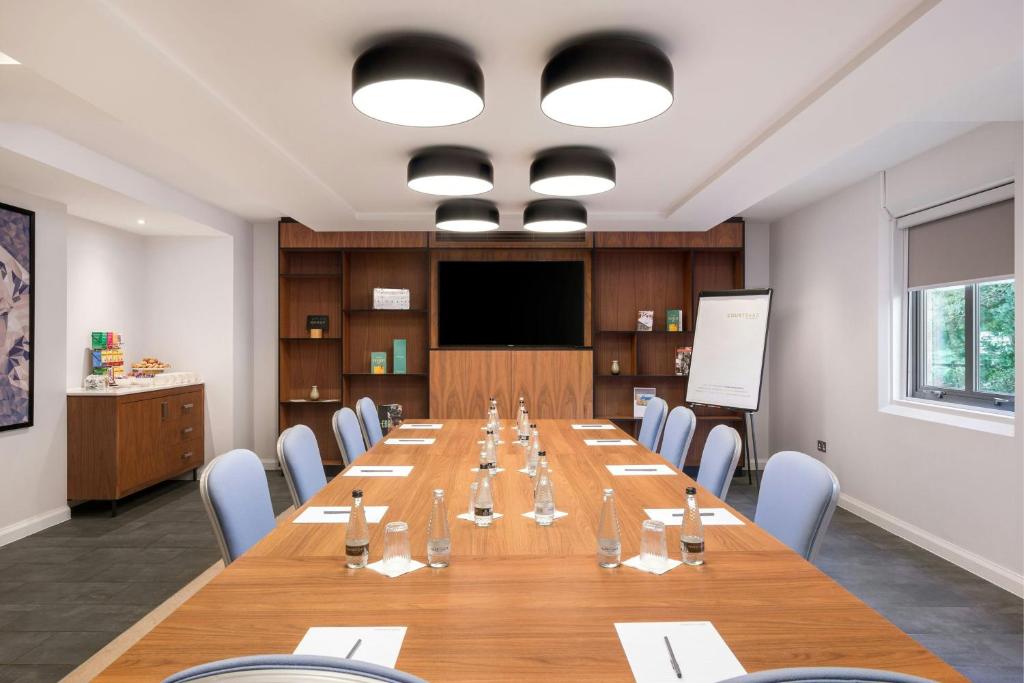 a large conference room with a long table and chairs at Courtyard by Marriott Glasgow Airport in Paisley