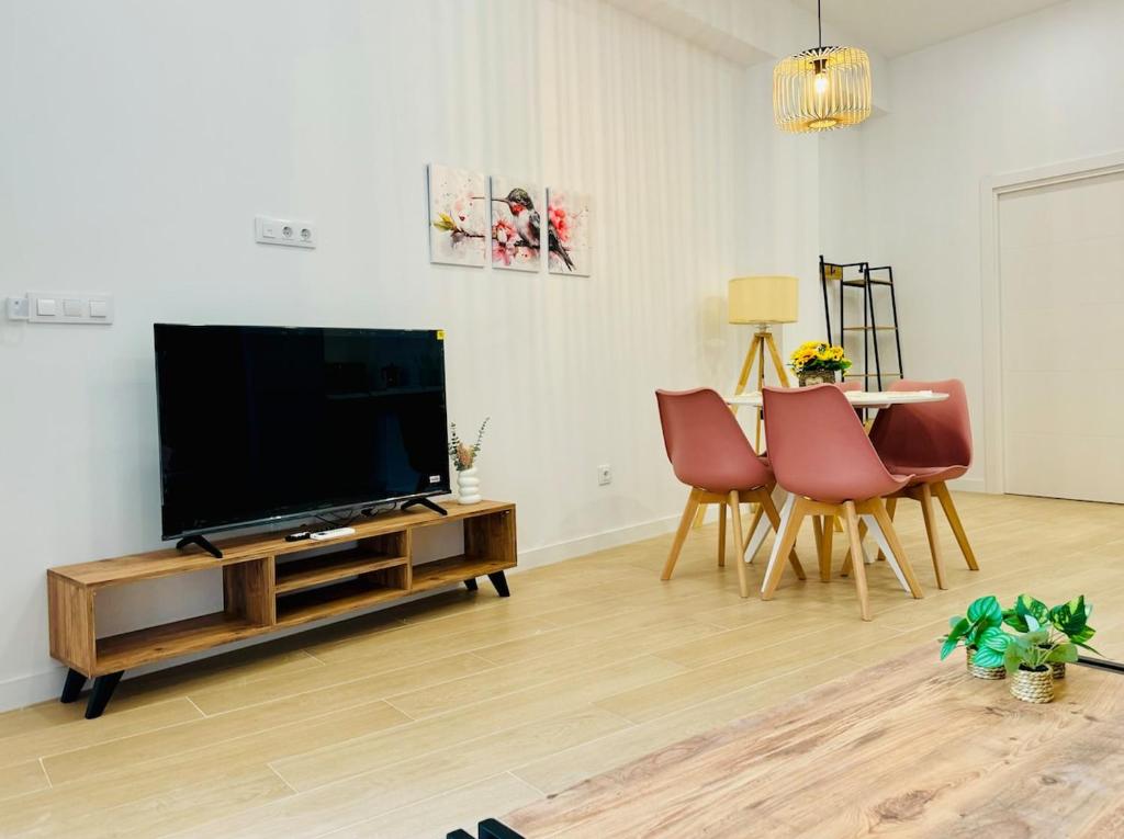 a living room with a flat screen tv and chairs at LOFT 3 - Space & Conform Close To Center in Valencia