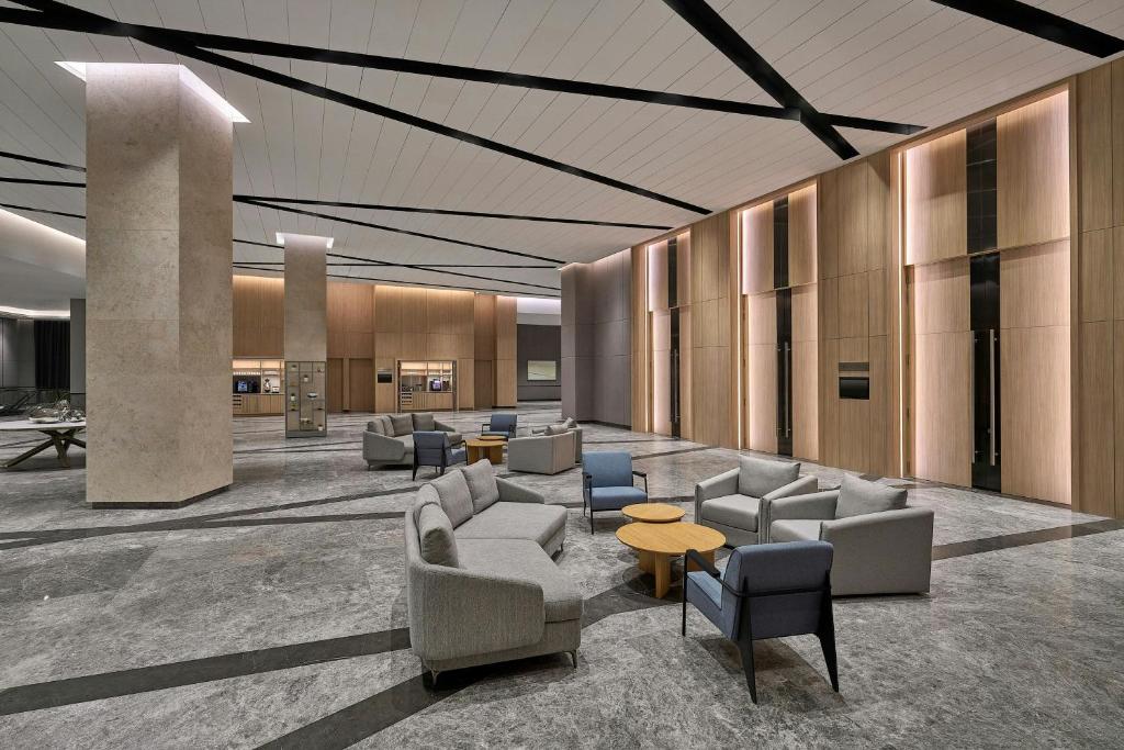 A spacious modern lobby with clustered lounge seating.