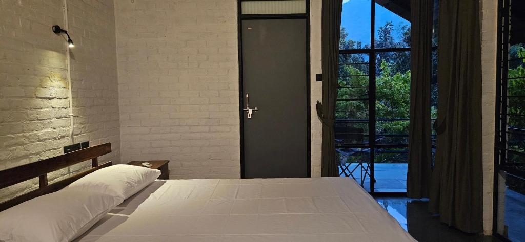 Postel nebo postele na pokoji v ubytování Pannadikadu Homestay