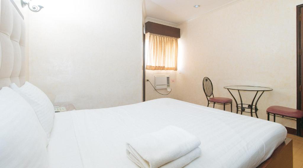 Postel nebo postele na pokoji v ubytování Bliss Hotel Dau
