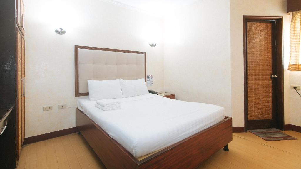 Postel nebo postele na pokoji v ubytování Bliss Hotel Dau