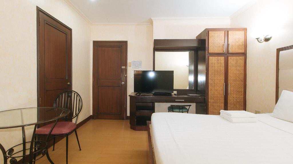 Postel nebo postele na pokoji v ubytování Bliss Hotel Dau