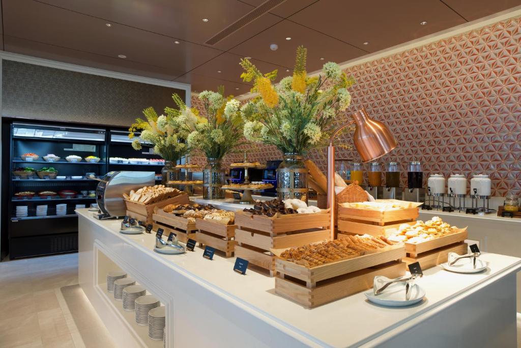 A bright bakery counter with breads, pastries and refrigerated foods.