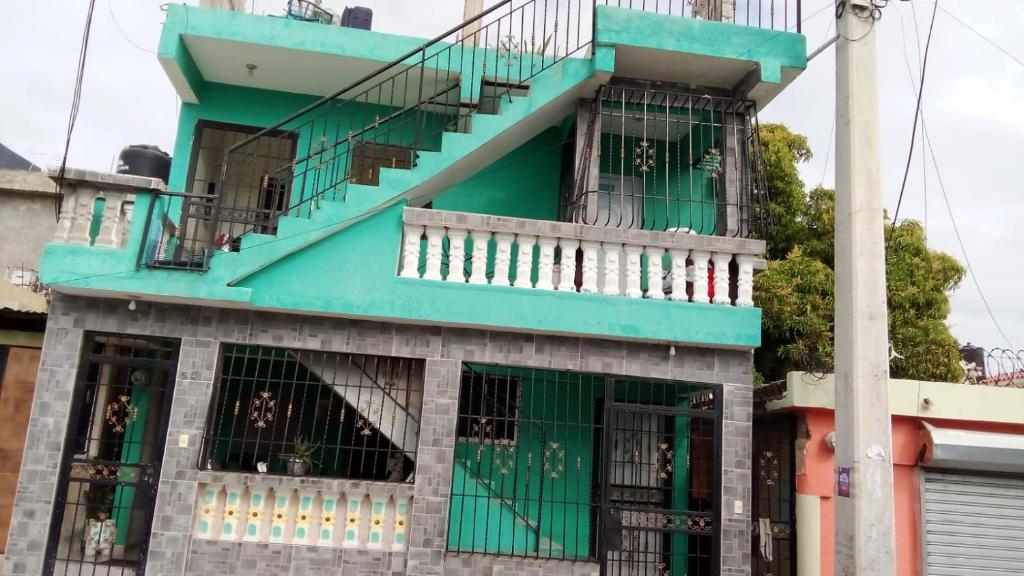 a blue building with a staircase on top of it at Chez Guela in Mandinga