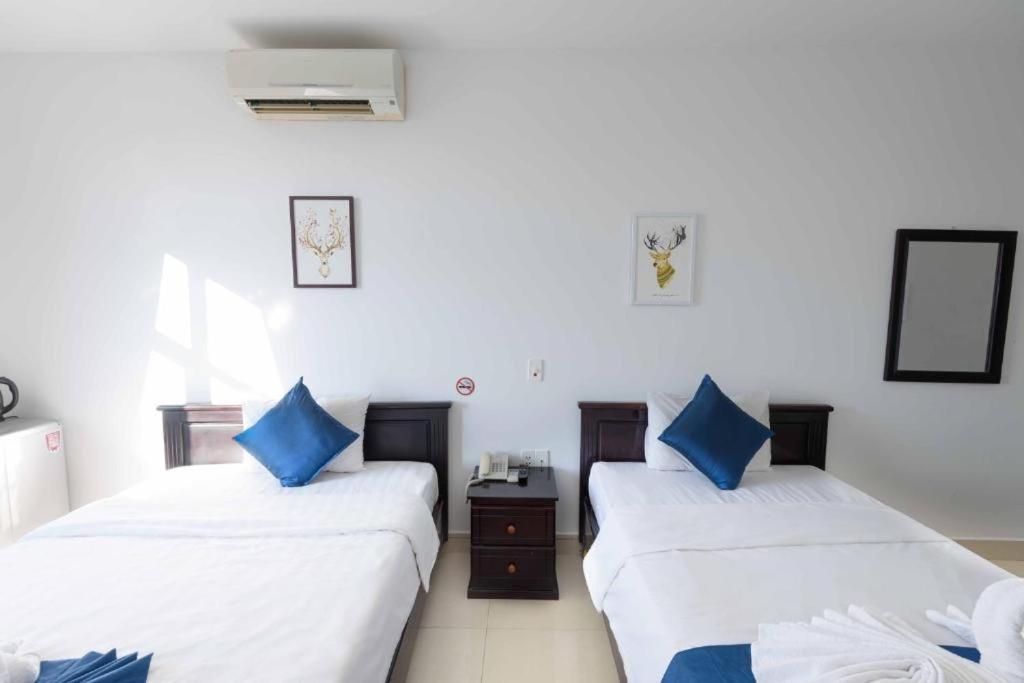 Postel nebo postele na pokoji v ubytování Tehana Beach Hotel Da Nang