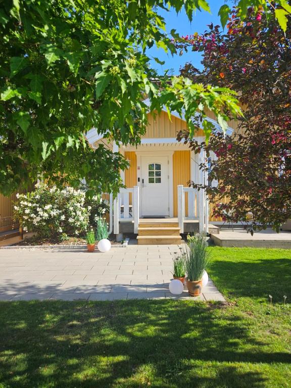 a house with a white door in a yard at Mysig villa Stockholm in Stockholm