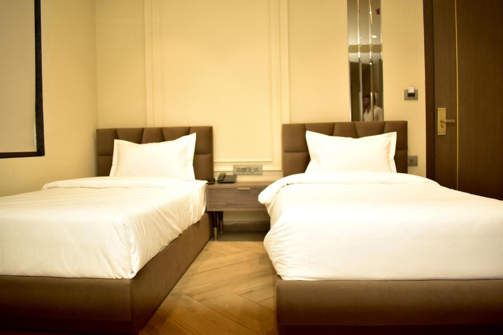 Postel nebo postele na pokoji v ubytování Hotel Cullinan By Qotel Janakpuri