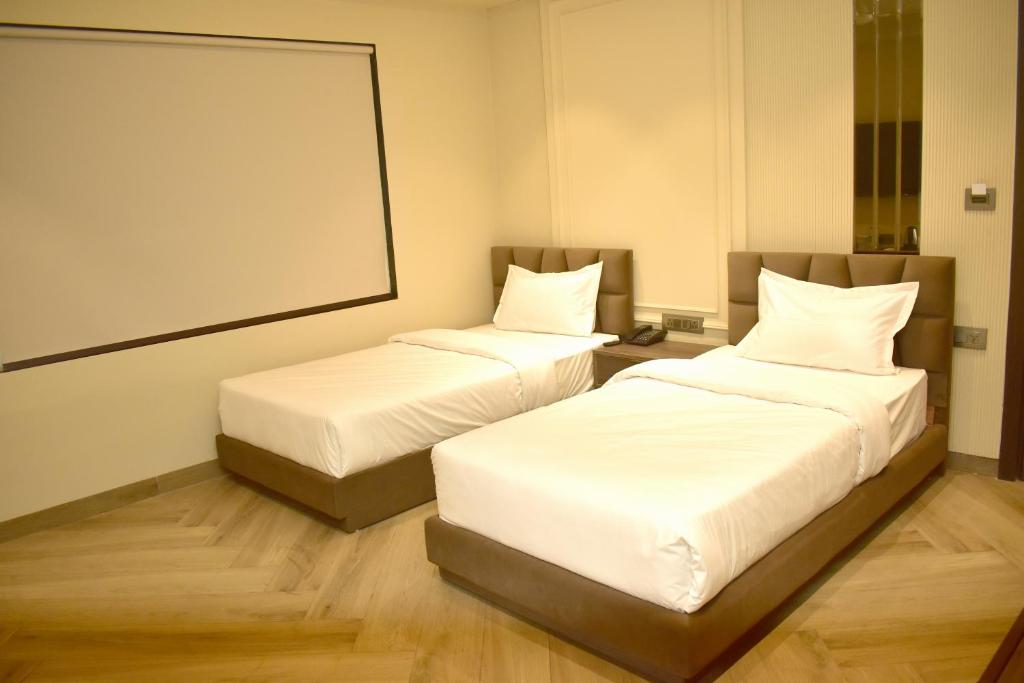 Postel nebo postele na pokoji v ubytování Hotel Cullinan By Qotel Janakpuri