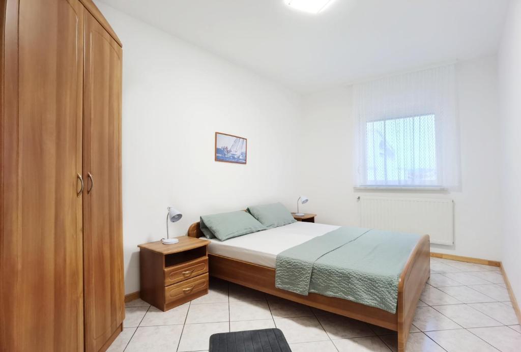 Postel nebo postele na pokoji v ubytování LiLu Apartments