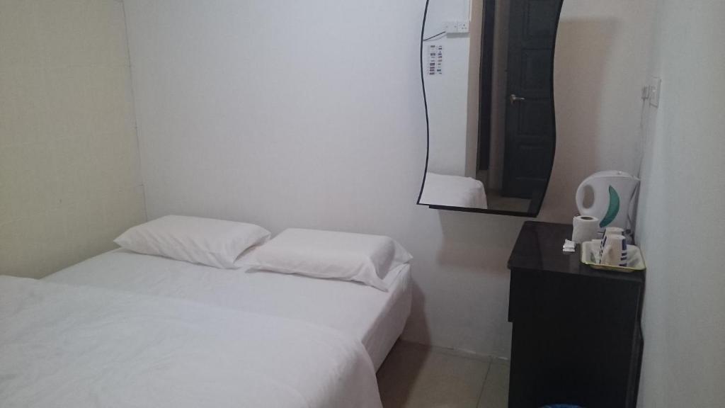 Postel nebo postele na pokoji v ubytování Axis Hotel