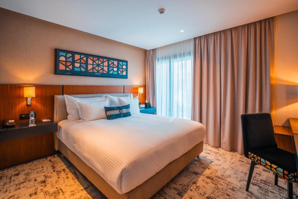 Postel nebo postele na pokoji v ubytování BRĂAT Hôtel