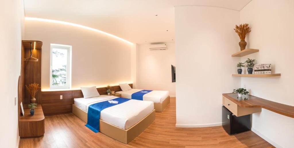 Giường trong phòng chung tại Le Huynh Mui Ne Hotel