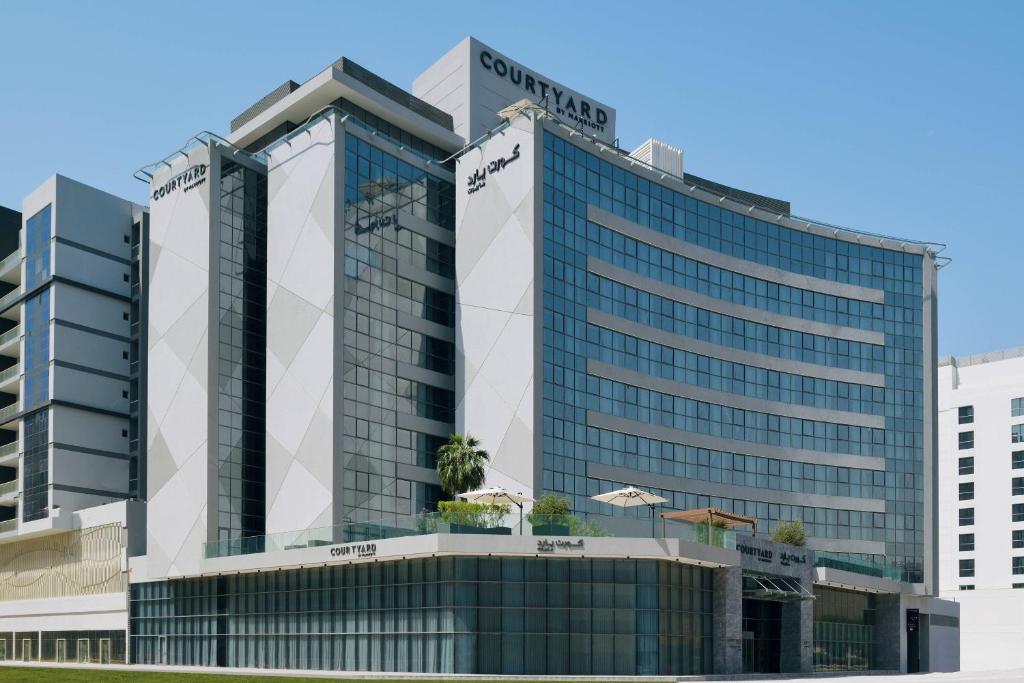 a tall building with a lot of windows at Courtyard by Marriott World Trade Centre, Dubai in Dubai